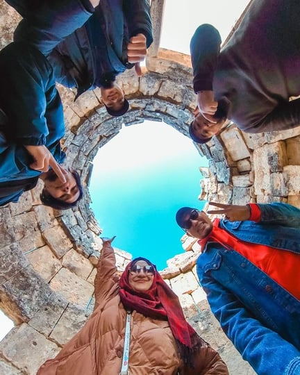 Pamukkale, Turkiye - a group of people looking up at the sky in a circular structure in Hierapolis