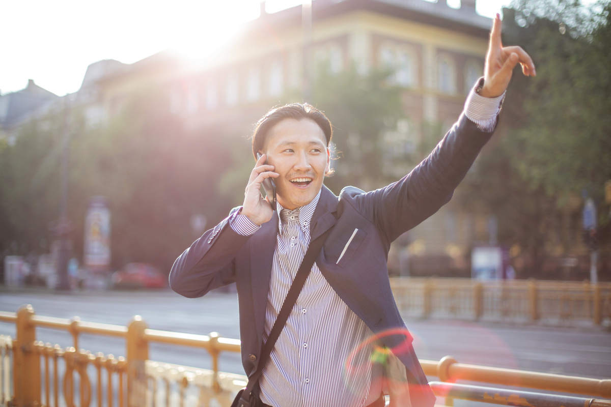 a person in a suit is talking on their cell phone using pocket wifi and international sim card or e-sim