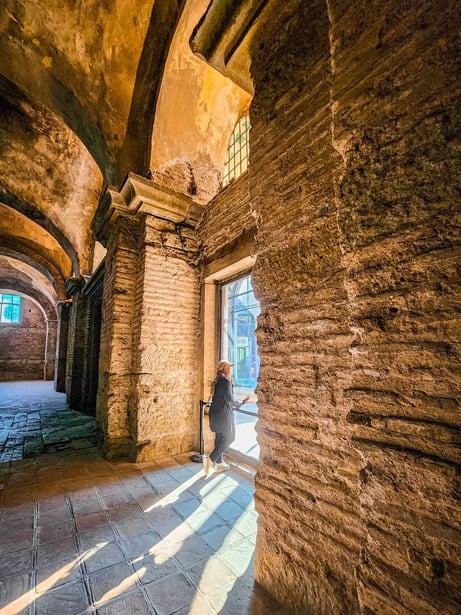 Istanbul, Turkiye - a person standing in the middle of an archway in an old building (Hagia Irene or Aya Irini, Topkapi Palace Museum)