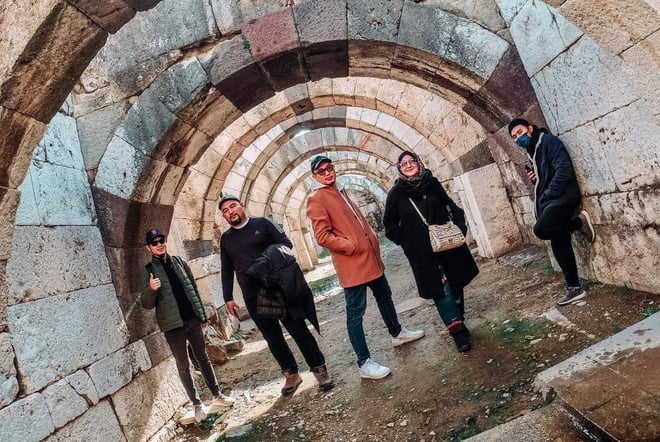 Izmir, Turkiye - a group of people standing in an aquaduct archway at Agora Open Museum