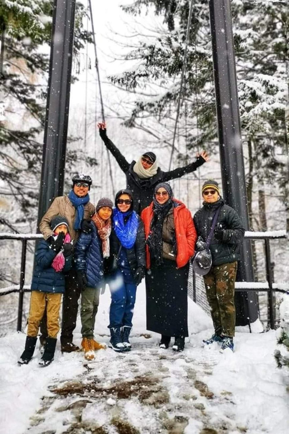 Hokkaido, Japan - a group of people posing for a picture in the snow, Fukidashi spring water park