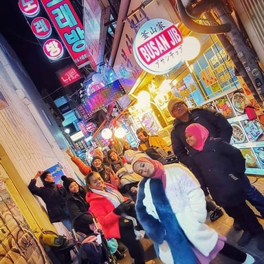 Seoul, South Korea - a group of people with Malaysian artist (Emma Maembong) posing for a photo in an alley in Myeongdong