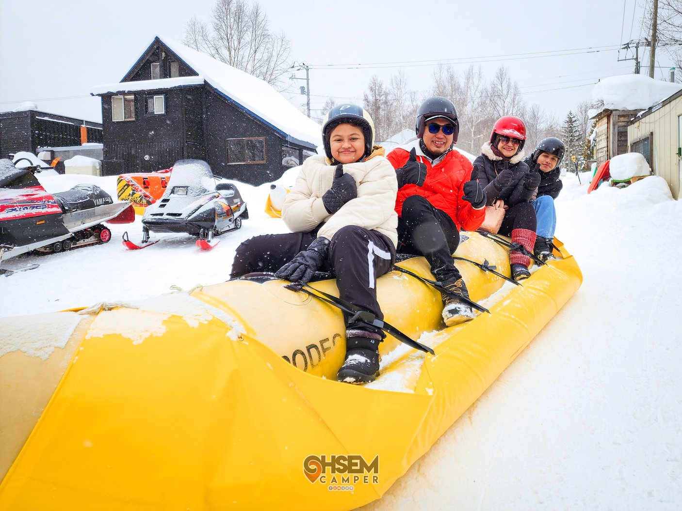 Hokkaido Japan - North Safari Sapporo, a group of people on an inflatable raft (Banana Boat) in the snow