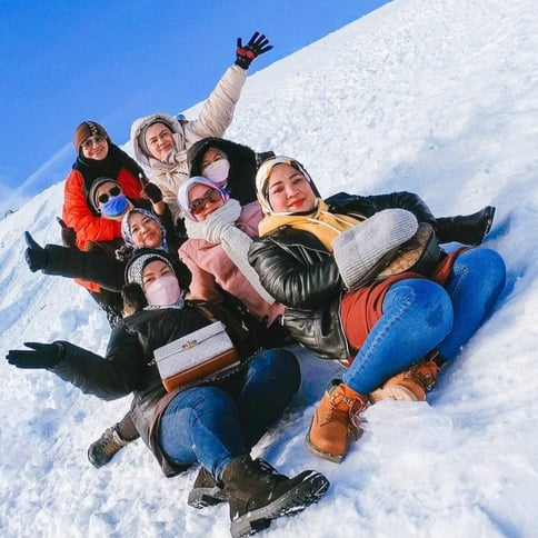 Istanbul, Turkiye - a group of people sitting on top of a snow covered hill at Erciyes Ski Resort